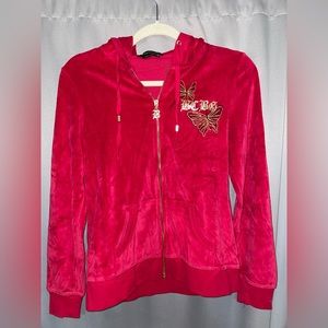 BCBG MaxAzria Red Hoodie with gold and black design.